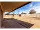 The spacious backyard offers brick features, a wooden fence, and tropical palms at 4813 N 62Nd Ave, Phoenix, AZ 85033