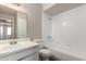 The bathroom has a modern vanity, mirror, and a tub with tile surround at 4813 N 62Nd Ave, Phoenix, AZ 85033