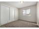 A well-lit bedroom offers neutral walls, plush carpet, and a built-in wardrobe for ample storage at 4813 N 62Nd Ave, Phoenix, AZ 85033