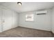 Neutral bedroom featuring plush carpet, an AC unit, and a window at 4813 N 62Nd Ave, Phoenix, AZ 85033