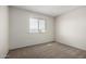 A cozy bedroom provides neutral paint, carpet and a window with blinds for natural light at 4813 N 62Nd Ave, Phoenix, AZ 85033