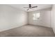 Neutral bedroom featuring a ceiling fan, window, and neutral carpet at 4813 N 62Nd Ave, Phoenix, AZ 85033