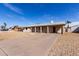 A well-maintained single-level home with a covered driveway and simple desert landscaping at 4813 N 62Nd Ave, Phoenix, AZ 85033