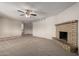 Inviting living space featuring a fireplace, modern ceiling fan, and a blend of carpet and tile flooring at 4813 N 62Nd Ave, Phoenix, AZ 85033