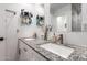 Bathroom featuring double sinks with granite counters and a well-lit mirror at 5030 S 23Rd Ave, Phoenix, AZ 85041