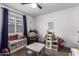 Bright bedroom with a ceiling fan, window with blinds, and ample space for a play area at 5030 S 23Rd Ave, Phoenix, AZ 85041