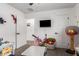Spacious bedroom featuring a door, a mounted television, and a dedicated play area with a basketball hoop at 5030 S 23Rd Ave, Phoenix, AZ 85041