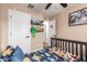 Cozy bedroom featuring a dinosaur-themed bed, and neutral walls at 5030 S 23Rd Ave, Phoenix, AZ 85041