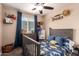 Charming bedroom featuring a dinosaur-themed bed, natural light, and decorative elements at 5030 S 23Rd Ave, Phoenix, AZ 85041