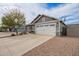 Single-Gathering home with desert landscaping and a spacious driveway leading to an attached two-car garage at 5030 S 23Rd Ave, Phoenix, AZ 85041