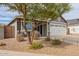 Single-Gathering home with a covered porch, desert landscaping, and an attached two-car garage at 5030 S 23Rd Ave, Phoenix, AZ 85041