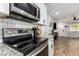 Modern kitchen featuring stainless steel appliances, granite countertops, and a stylish tile backsplash at 5030 S 23Rd Ave, Phoenix, AZ 85041
