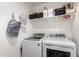 Functional laundry room featuring modern washer and dryer units, plus overhead storage for laundry supplies at 5030 S 23Rd Ave, Phoenix, AZ 85041