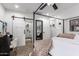 Spacious main bedroom with walk-in shower, double closet, and modern barn door at 5030 S 23Rd Ave, Phoenix, AZ 85041