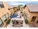 Aerial view of a backyard featuring an outdoor seating area, gravel beds, and well-maintained landscaping at 5203 N 179Th Dr, Litchfield Park, AZ 85340