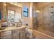 Well-lit bathroom features shower stall, single sink vanity, and a toilet at 5203 N 179Th Dr, Litchfield Park, AZ 85340