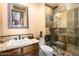 Bathroom featuring granite countertops, tile shower and decorative mirror at 5203 N 179Th Dr, Litchfield Park, AZ 85340