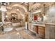 Opulent bathroom showcasing dual vanities, a soaking tub, and unique architectural details at 5203 N 179Th Dr, Litchfield Park, AZ 85340