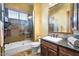 Bathroom featuring stone tile shower, soaker tub and granite countertop vanity at 5203 N 179Th Dr, Litchfield Park, AZ 85340