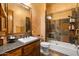 Bathroom featuring stone tile shower, soaker tub and granite countertop vanity at 5203 N 179Th Dr, Litchfield Park, AZ 85340