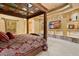 Luxurious bedroom with a four-poster bed, tray ceiling, and built-in media niche at 5203 N 179Th Dr, Litchfield Park, AZ 85340