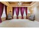 Spacious bedroom with decorative ceilings, ornate drapes, and stylish seating at 5203 N 179Th Dr, Litchfield Park, AZ 85340