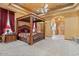 Spacious bedroom suite boasts a four-poster bed, tray ceilings, and fireplace at 5203 N 179Th Dr, Litchfield Park, AZ 85340