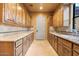 Spacious butler's pantry features beautiful wood cabinets, countertop space, and convenient access to other areas of the home at 5203 N 179Th Dr, Litchfield Park, AZ 85340
