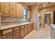 Well-appointed butler's pantry includes a sink, wooden cabinetry, counter space, and laundry area, enhancing functionality at 5203 N 179Th Dr, Litchfield Park, AZ 85340