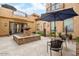 Outdoor courtyard featuring a decorative fountain, comfortable seating area, and privacy from balconies above at 5203 N 179Th Dr, Litchfield Park, AZ 85340