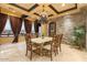 Elegant dining room with stone accent wall, coffered ceilings, stylish chandelier and grand dining table at 5203 N 179Th Dr, Litchfield Park, AZ 85340