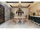 Elegant dining room featuring a stone accent wall, decorative chandelier, and dining table at 5203 N 179Th Dr, Litchfield Park, AZ 85340