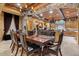 Formal dining room with wood beams, chandelier, and adjacent to kitchen at 5203 N 179Th Dr, Litchfield Park, AZ 85340