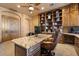Home Office with a granite desk, a leather chair, and a large bookcase at 5203 N 179Th Dr, Litchfield Park, AZ 85340