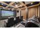 Home theater room with large screen, coffered ceilings, recessed lighting, and reclining theater seating at 5203 N 179Th Dr, Litchfield Park, AZ 85340