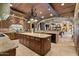 Gourmet kitchen featuring granite countertops, wooden cabinets, and large island at 5203 N 179Th Dr, Litchfield Park, AZ 85340