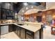 Gourmet kitchen featuring granite countertops, dark wood cabinetry and breakfast bar at 5203 N 179Th Dr, Litchfield Park, AZ 85340