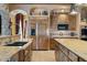 Gourmet kitchen with custom cabinetry and stainless steel appliances at 5203 N 179Th Dr, Litchfield Park, AZ 85340