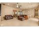 Living room featuring neutral walls, a ceiling fan, and two comfortable sofas, great for entertaining at 5203 N 179Th Dr, Litchfield Park, AZ 85340