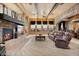 Elegant living room featuring a stone fireplace, beamed ceiling, and neutral decor at 5203 N 179Th Dr, Litchfield Park, AZ 85340