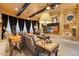 Sophisticated living room with a large fireplace, beamed ceilings and custom lighting at 5203 N 179Th Dr, Litchfield Park, AZ 85340