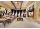 Open-concept living room with stone archways and fireplace, great for entertaining at 5203 N 179Th Dr, Litchfield Park, AZ 85340
