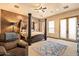 Spacious main bedroom featuring a canopy bed, a sitting area and outdoor access at 5203 N 179Th Dr, Litchfield Park, AZ 85340