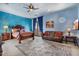 Main bedroom includes a bed, seating, lamps and a beautiful blue accent wall at 5203 N 179Th Dr, Litchfield Park, AZ 85340