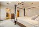 Luxurious main bedroom boasts a decorative canopy bed and en suite bath access at 5203 N 179Th Dr, Litchfield Park, AZ 85340