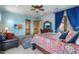 Spacious main bedroom features blue walls, wooden accents, TV, and a large bed with patterned bedding at 5203 N 179Th Dr, Litchfield Park, AZ 85340