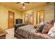 Comfortable bedroom with decorative pillows, an adjacent bathroom, and a dresser providing ample storage at 5203 N 179Th Dr, Litchfield Park, AZ 85340
