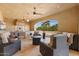 Covered outdoor living space featuring a bar, seating and views of the backyard at 5203 N 179Th Dr, Litchfield Park, AZ 85340