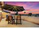 Cozy patio featuring an umbrella, scenic city views, and comfortable seating at 5203 N 179Th Dr, Litchfield Park, AZ 85340