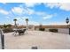 The outdoor patio features a fireplace, seating, and desert landscaping for elegant entertaining at 5203 N 179Th Dr, Litchfield Park, AZ 85340